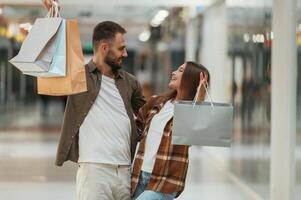 Shopping is, finished. Young couple are in supermarket together photo