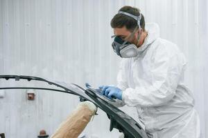 Metal,, carcass. Repairman is working in the garage photo