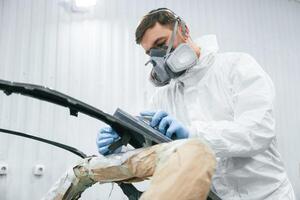 Metal ,carcass.. Repairman is working in the garage photo