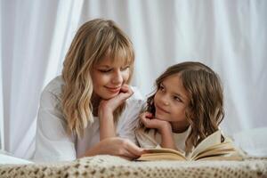 Reading ,the,, book together. Mother with daughter are at home photo