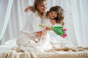 Mother's day. With daughter and, flowers. At home together photo