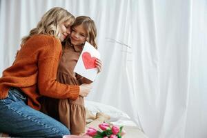 Conception of mother's day, celebration. Parent with daughter at home photo