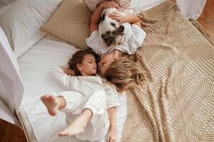 View from, the top, lying down on bed. Mother with daughter are at home together photo
