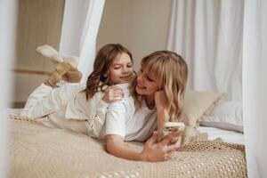 Mother, with daughter are at home together photo