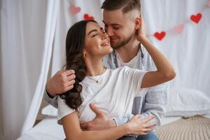 Front view, embracing each other.,, Young couple are together at home photo