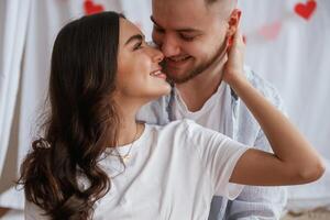Front view, embracing, each, other. Young couple are together at home photo