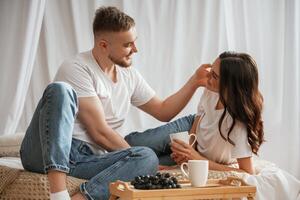 Grape, and cups of drink. Young,, couple are together at home photo