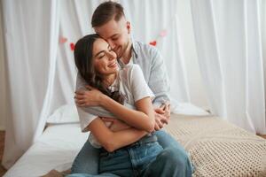 In casual, clothes, embracing, each other. Young couple are together at home photo