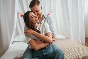 Conception of, Valentine's day, embracing. Young couple are together at home photo