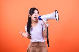 Woman Using Megaphone on Orange Background, Making an Announcement or Protest photo