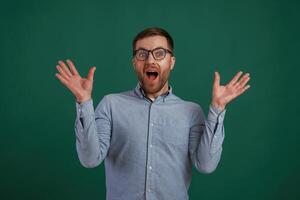 Shocked facial expression. Man is standing against background in the studio photo
