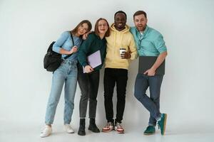 Looking forward. Group of, young people are standing against white background photo