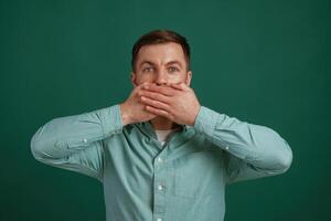 Shocked, facial ,,expression. Man is standing against background in the studio photo