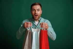 Shocked, facial expression. Man is standing against background in the studio photo
