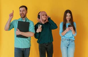 With,, technology. Group of friends are in the studio against background photo