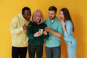 With, technology. Group of friends are in the studio against background photo