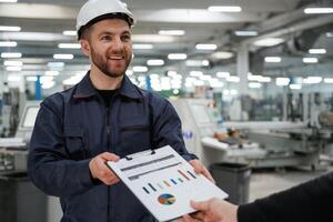 Giving the document with plan. Man, on ,the factory is making deal with other person photo