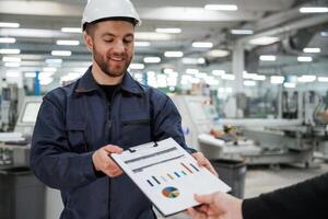 Giving the document with plan.,, Man on the factory is making deal with other person photo