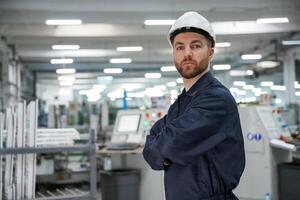 Smart employee. Factory worker is ,indoors ,with hard hat photo