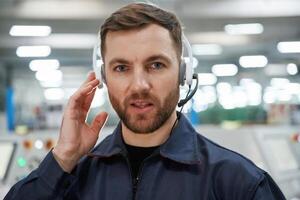 Portrait of, factory ,,worker that is indoors with headphones photo