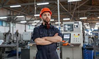 Confident facial,, expression. Factory worker is indoors with hard hat photo
