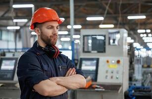 Confident facial, expression. Factory ,worker is indoors with hard hat photo