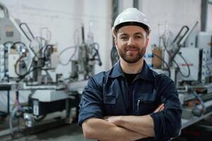 Front view. Factory worker ,is ,,indoors with hard hat photo