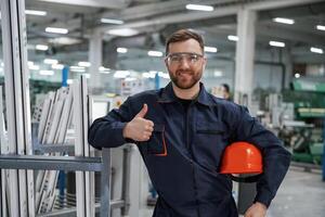 Break,, time, standing. Factory worker is indoors with hard hat photo