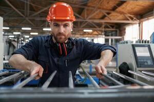 Industrial ,line, working. Factory ,worker is indoors with hard hat photo
