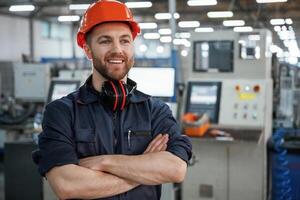 Front view. Factory, worker is indoors with hard hat photo