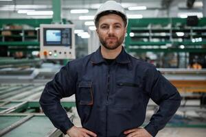 Against ,machine. Factory, worker is indoors with hard hat photo