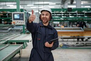 Giving, orders by hand. Factory worker, is indoors with hard hat photo