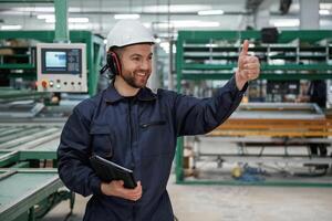 Giving, orders by hand. Factory, worker ,,is indoors with hard hat photo
