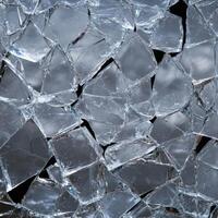 Shattered glass pieces create an abstract, fractured pattern photo