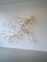 Abstract sculpture of a running man on white wall photo