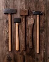 Vintage mallets and tools on rustic wooden surface photo