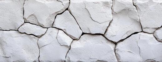 Cracked white stone wall texture background with rough surface photo