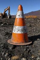 Gritty construction cone stands on a construction site photo