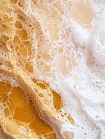 Golden and white foam texture background, abstract bubbly surface photo
