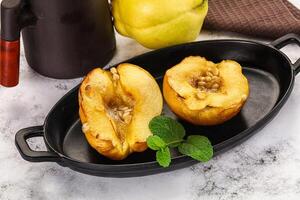 A black dish with two halves of a peach photo
