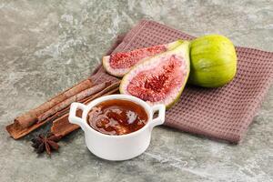 Figs and cinnamon on a cloth with a cup of honey photo
