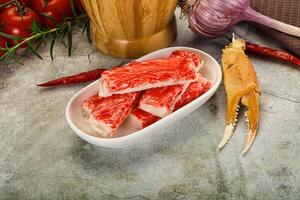 Raw crab meat in a bowl with tomatoes and garlic photo