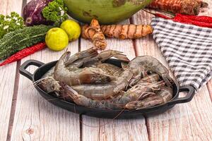 A pan full of shrimp sitting on a table photo