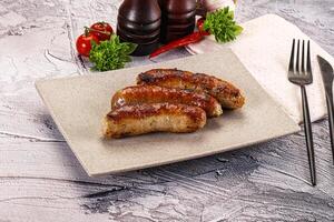 A plate with three sausages on it photo