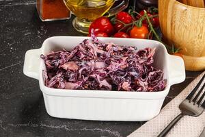 A white dish with red cabbage in it photo