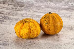 Two small yellow squash on a table photo