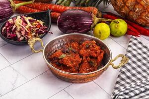 A bowl of food with vegetables and fruit on a table photo