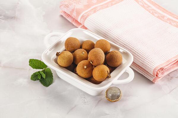 A white dish with a bunch of kiwis in it