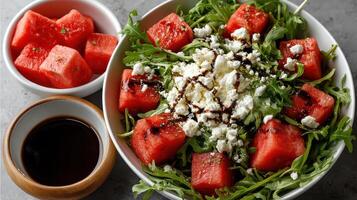 Fresh salad with watermelon, arugula, and feta cheese, drizzled with balsamic glaze photo