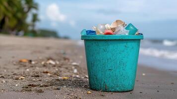 vibrant bucket filled with ocean plastics sits on sandy beach, highlighting pollution impact photo